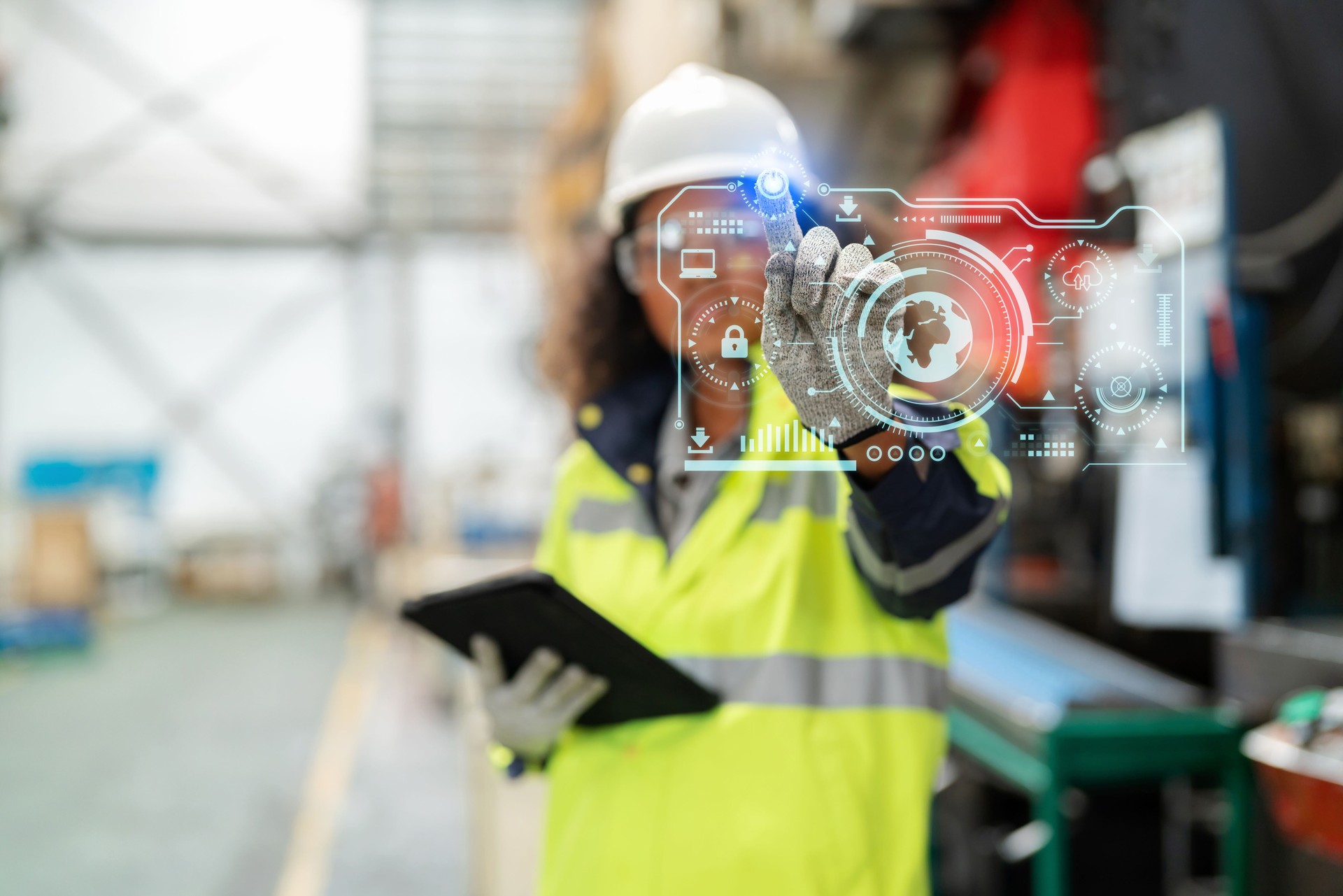 Increasing factory standards creates confidence for consumers. Asia in refractive safety suit with personal protective equipment (PPE) standing in the production line at factory holding tablet and point to the futuristic digital graphic screen